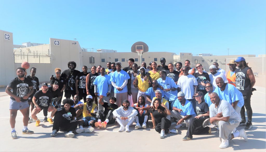 Group photo of incarcerated players and Between the Lines volunteers and staff.