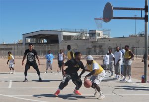 Incarcerated people play basketball against Between the Lines volunteers at Calipatria State Prison.