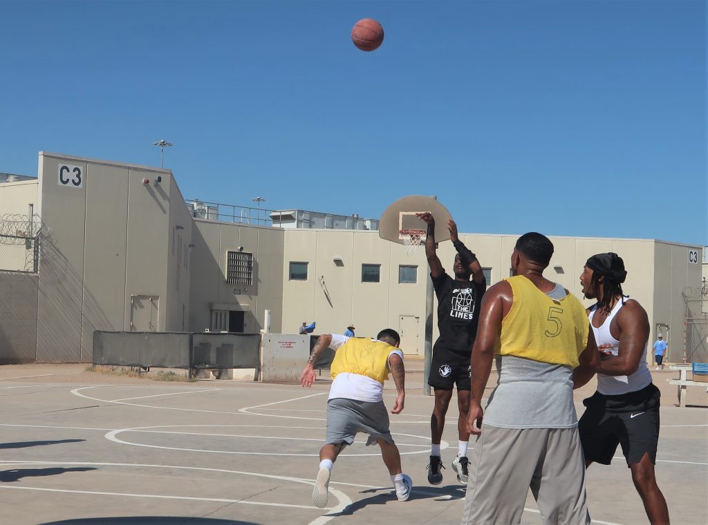 A volunteer takes a free throw at Calipatria State Prison during a basketball game.