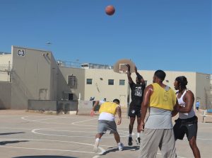 A volunteer takes a free throw at Calipatria State Prison during a basketball game.