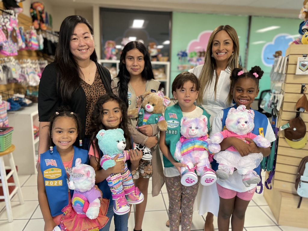 children standing together with stuffed animals