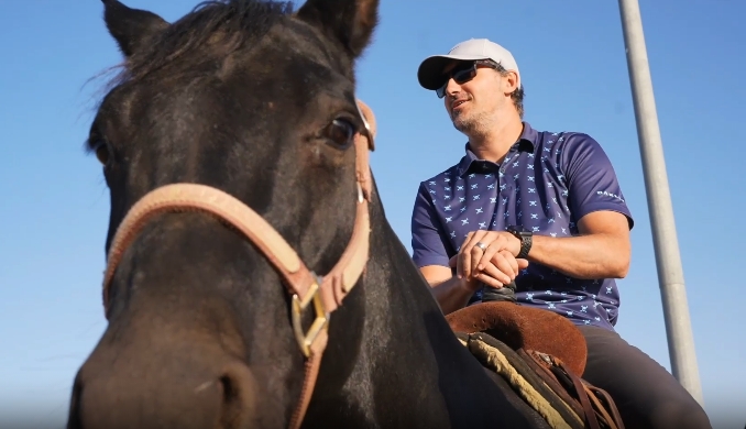 A CDCR coach sits on a horse.