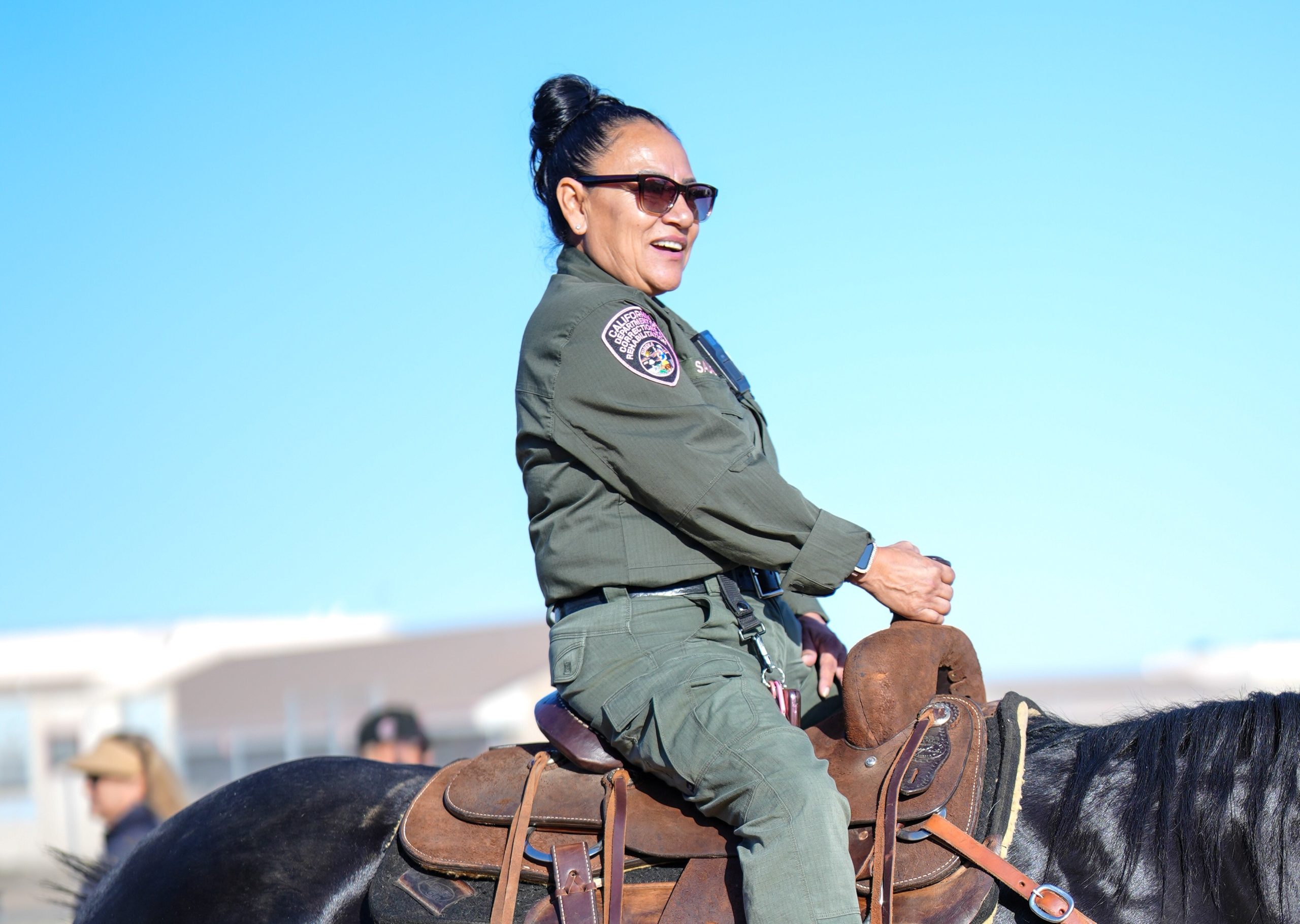 A correctional officer rides a horse at Central California Women's Facility (CCWF) during staff appreciation day.