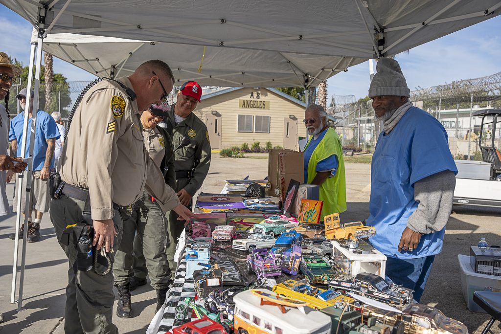 Correctional staff looks at table at cancer walk at CIM.