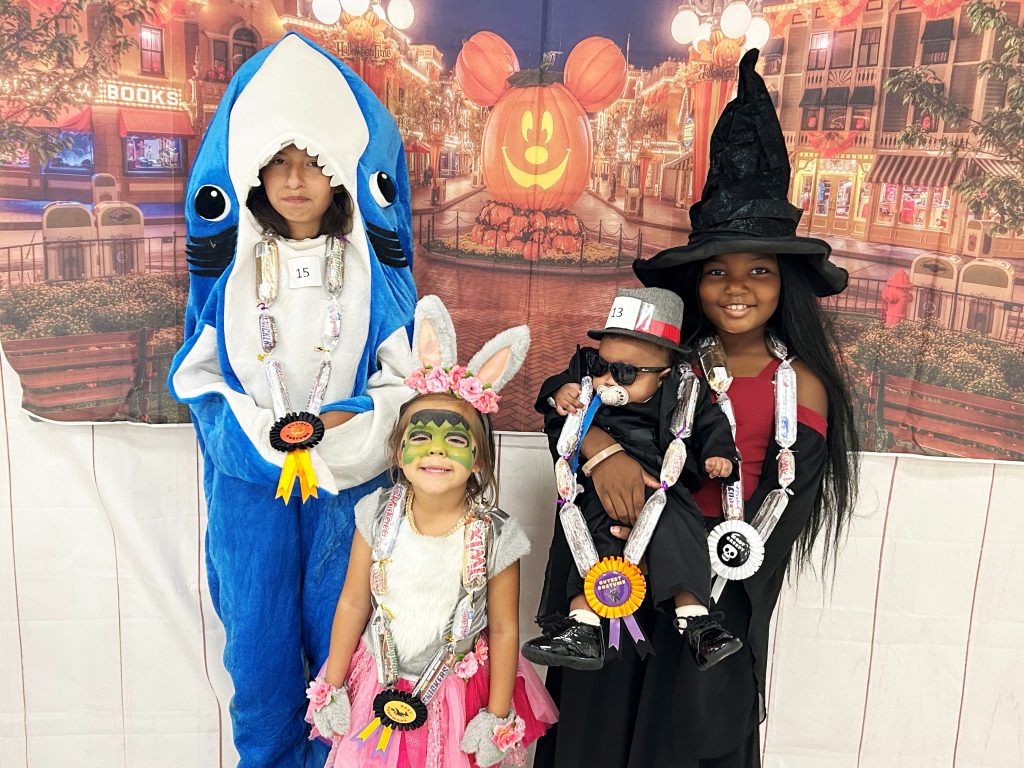 Four children wearing costumes at California Institution for Women.