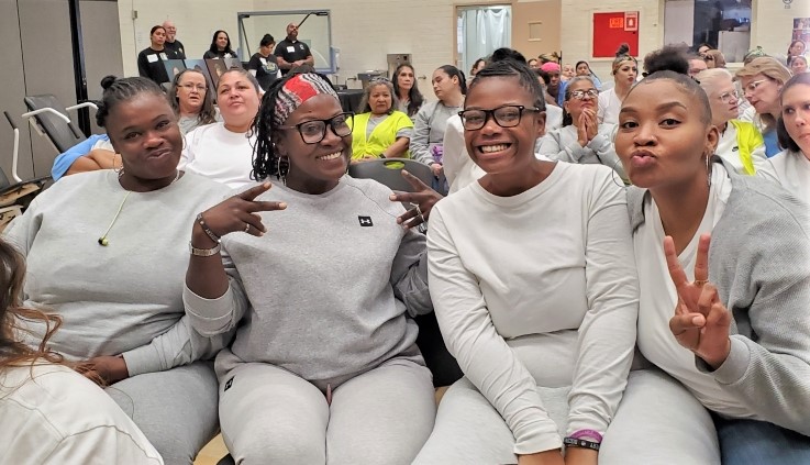 Women at CIW smile for the camera.