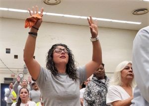 A woman raises her hands during a sobriety resource fair at CIW.
