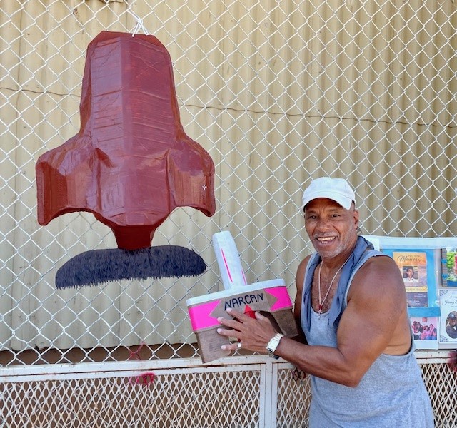 California Men's Colony with person standing beside an art piece.