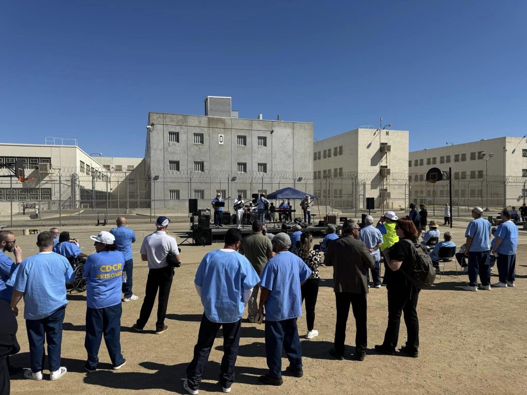 A group at California Medical Facility listening to a band.