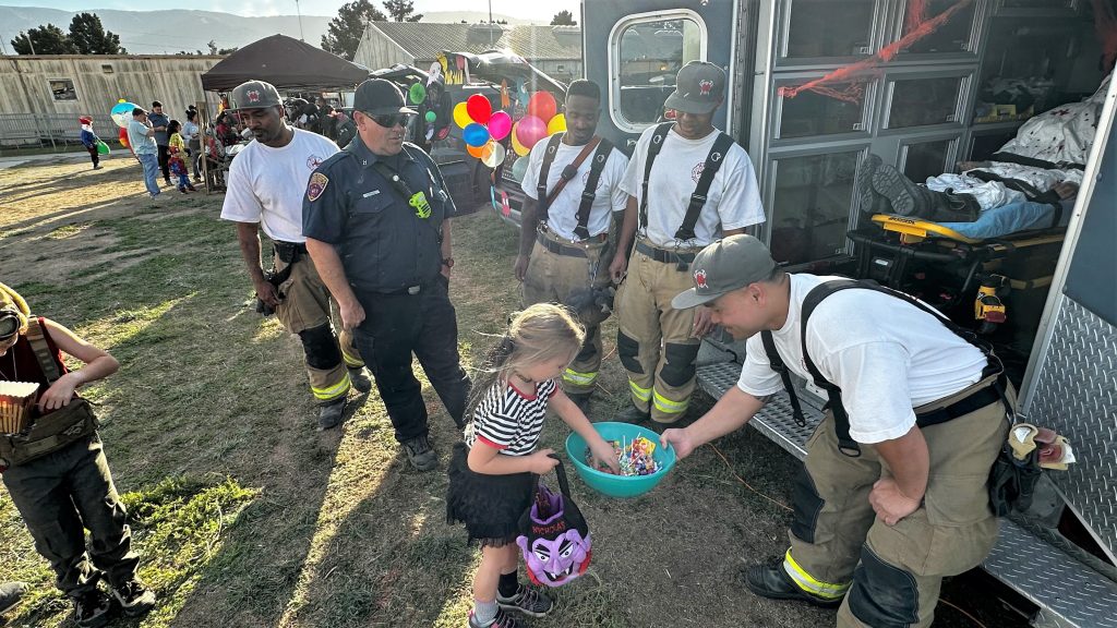 CTF firefighters pass out Halloween candy at Trunk-4-Treats.