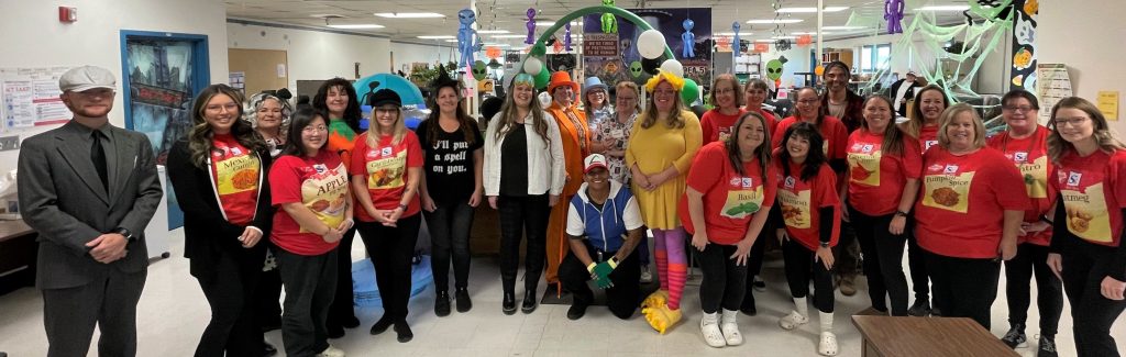Group photo of staff wearing costumes at the prison.