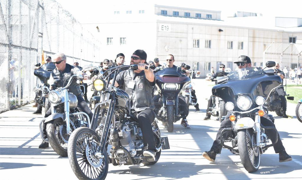 A group of riders bring motorcycles into Mule Creek State Prison.