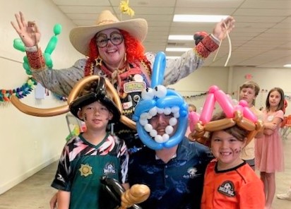 Mule Creek State Prison Family Fun Day with people holding balloon animals.