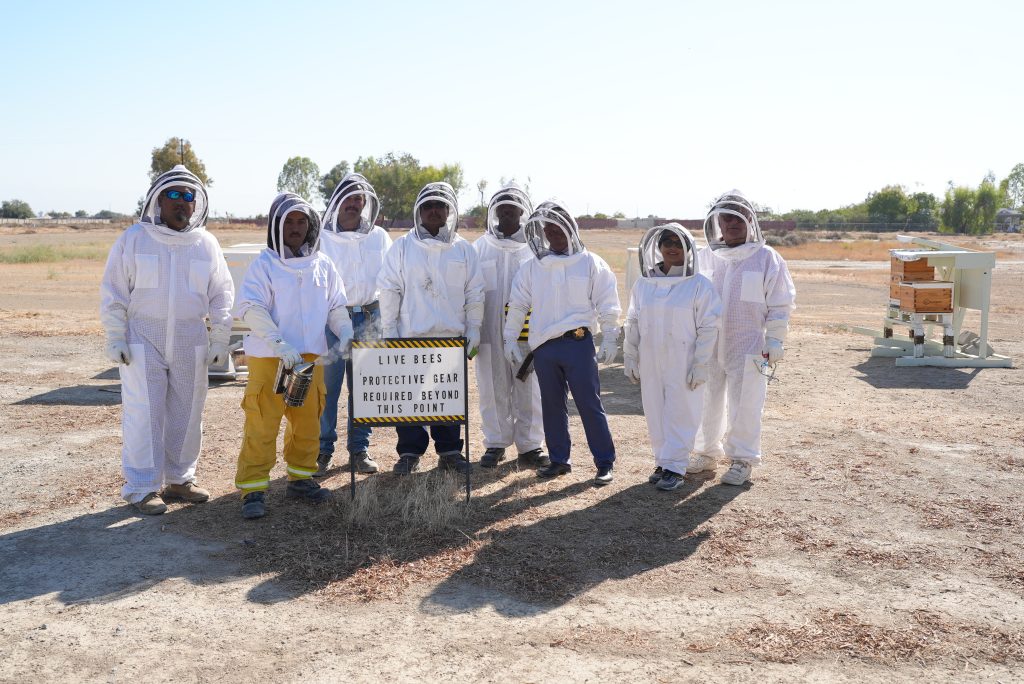 People wearing bee suits.