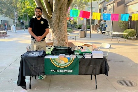 victim services staff standing at booth