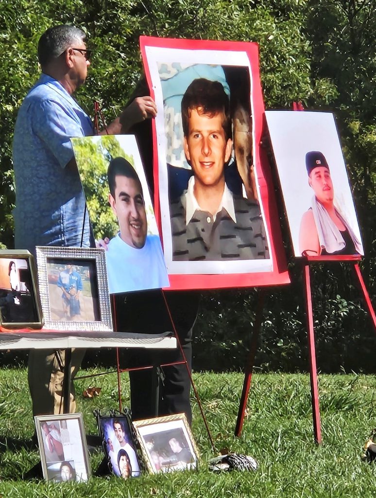 A man places a photo of a murdered person on an easel. 