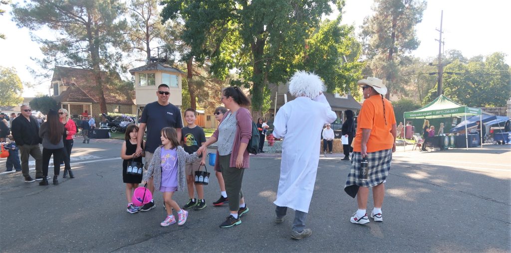 Costumed families walk around institution grounds at Folsom and CSP-Sacramento.
