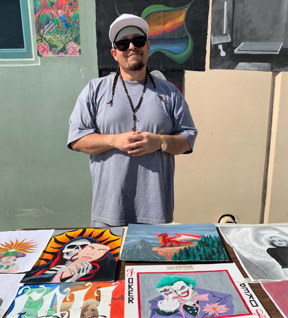 An incarcerated artist shows his work during the event.