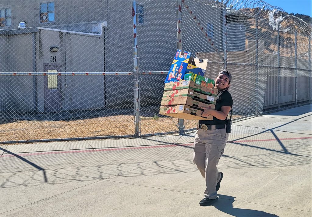A person carries boxes of snacks.