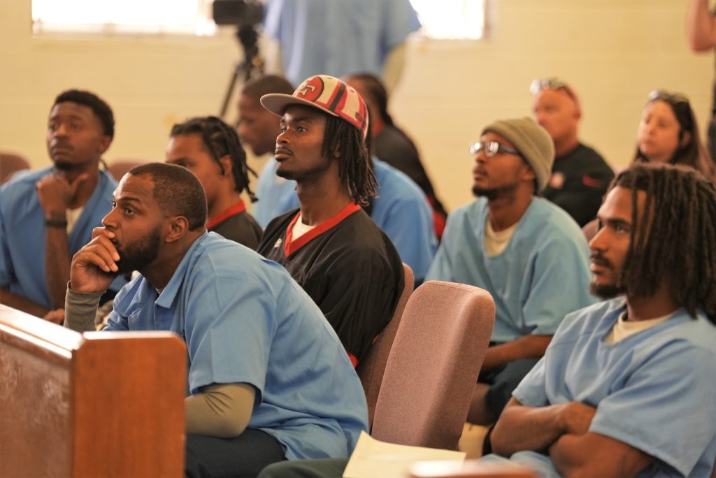 Incarcerated people an NFL Inspire Change representatives in the audience of the San Quentin chapel.