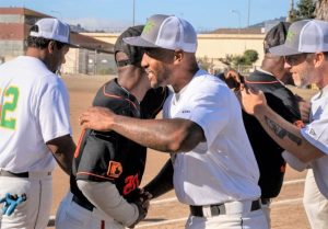San Quentin and California Medical Facility teams congratulate each other after the game.