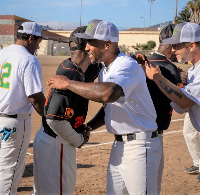 two incarcerated hug at softball game