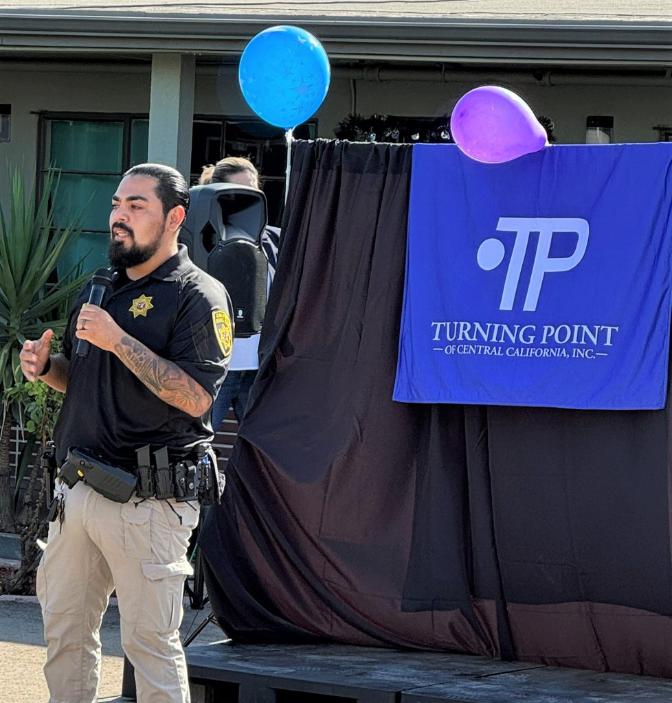 DAPO staff speaking at Turning Point Belgravia with mic