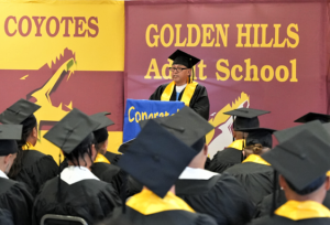 Gilberto Aguilar, one of the graduates, speaks during the ceremony at Avenal State Prison.