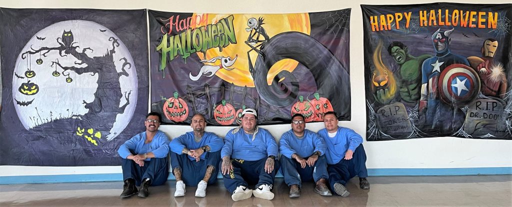 Artists with their paintings for Halloween visiting in the CDCR prison at Tehachapi.