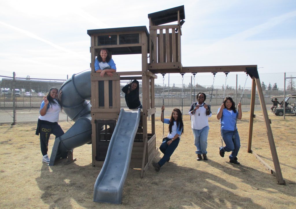 Incarcerated people test out the new play set at CCWF.