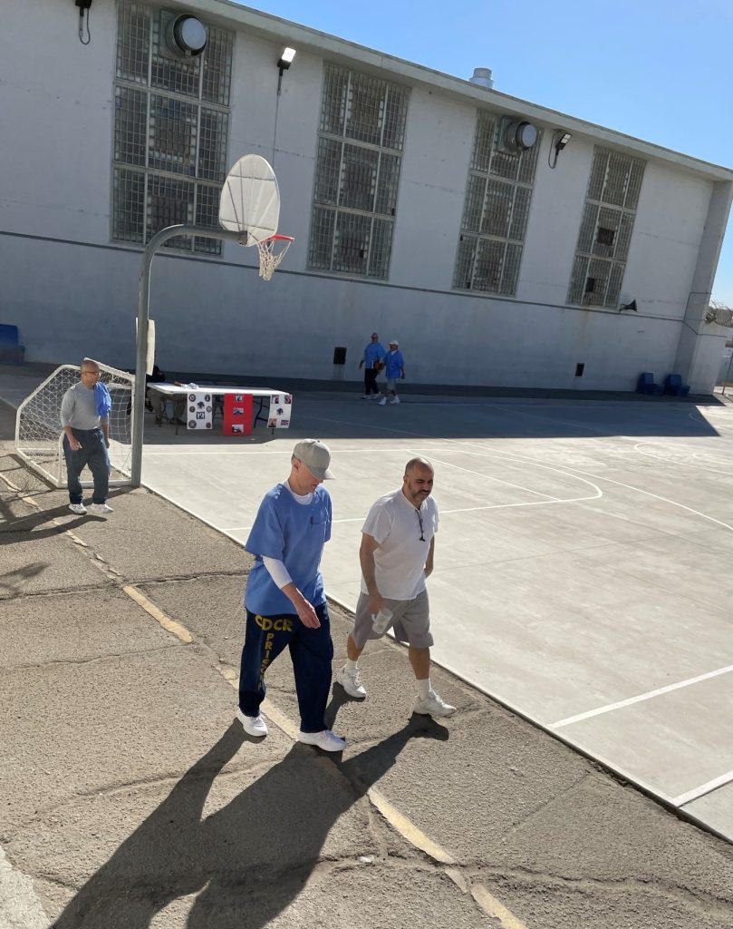 Two men walking for veterans at California Institution for Men.