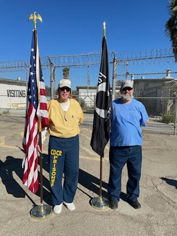 Incarcerated veterans holding flags.