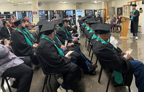 graduates sitting and listening to speaker at ceremony