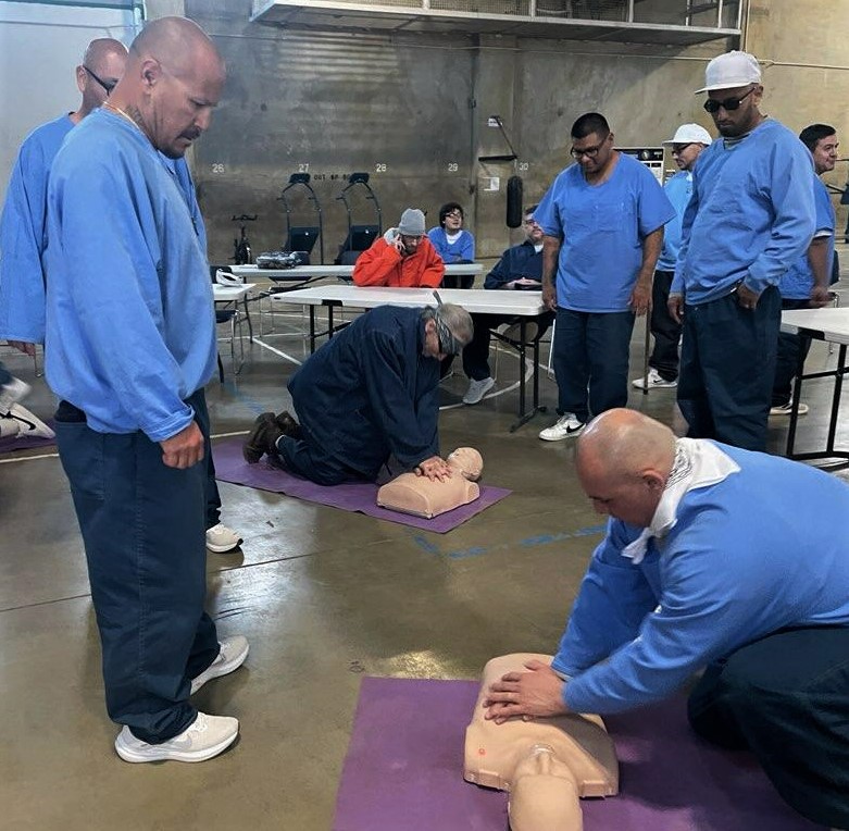 incarcerated people conducting CPR on mannequins