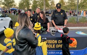 Parole staff took time to celebrate with the community at a trunk-or-treat festival in Elk Grove. Capitol District parole staff are shown handing out candy.