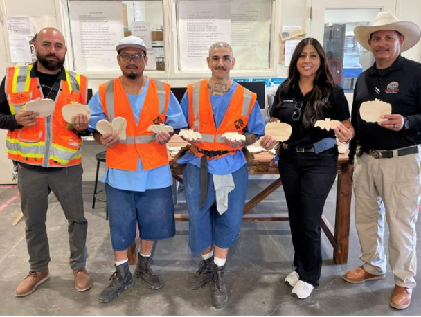 three incarcerated standing with two staff