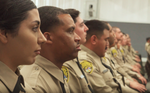 Correctional Officer Massey, an Air Force Reserve master sergeant, sits at the CDCR graduation.