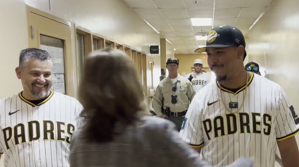 Padres meet RJD staff in a hallway at the institution.