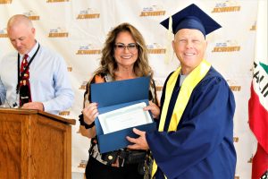 Students receive degrees and diplomas at the SATF graduation.