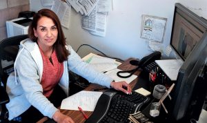 Maria Zamora, correctional counselor, sits at her desk at Central California Women's Facility in Chowchilla.