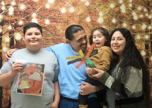 Visiting for Thanksgiving with family posing for a photo.