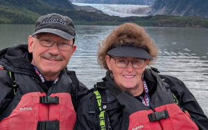 Avenal State Prison Associate Warden Groves is looking forward to retirement and this photo shows him with a woman and water behind them.