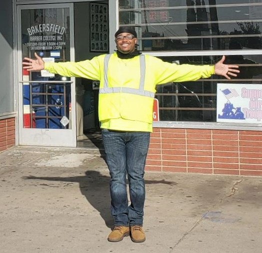 Christopher Hunt standing with arms open