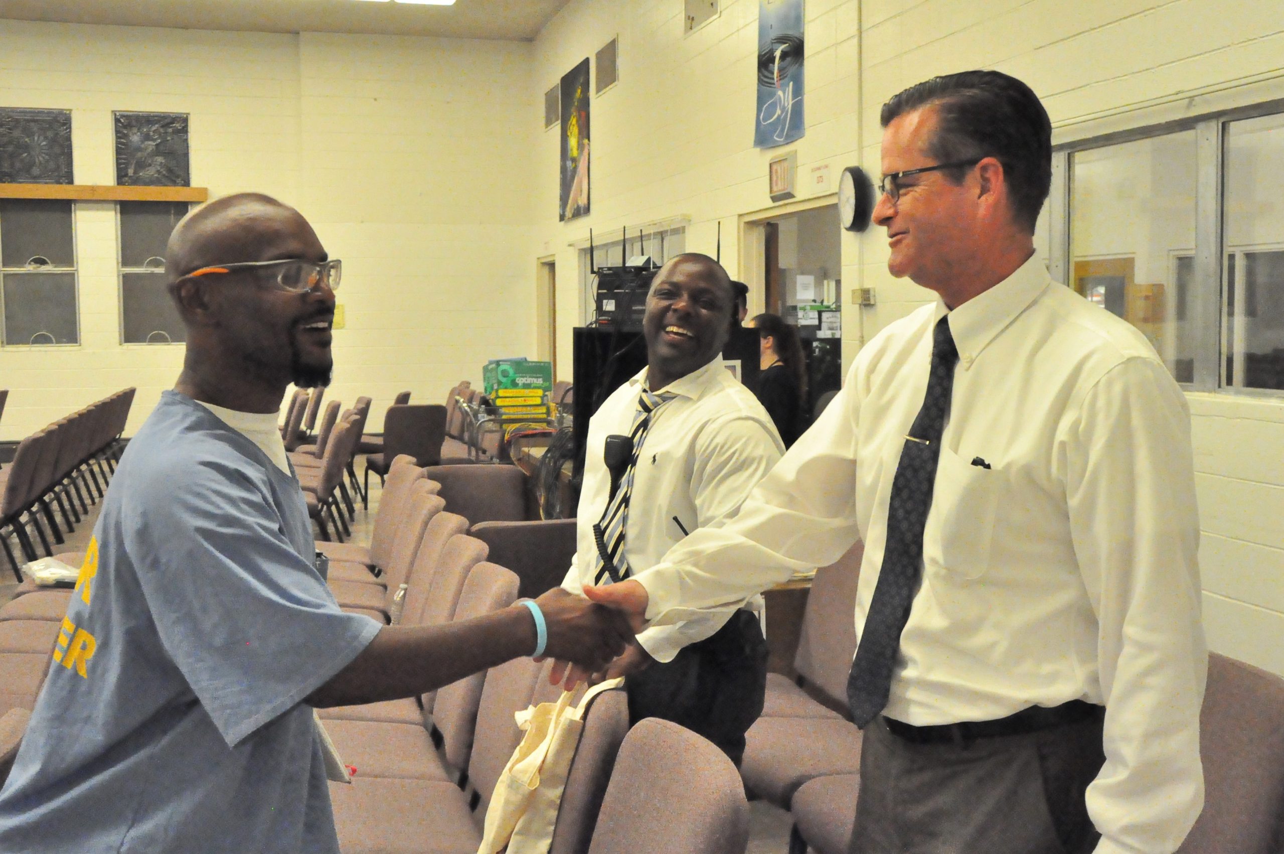 Ron Broomfield shakes hands with an incarcerated individual at San Quentin.