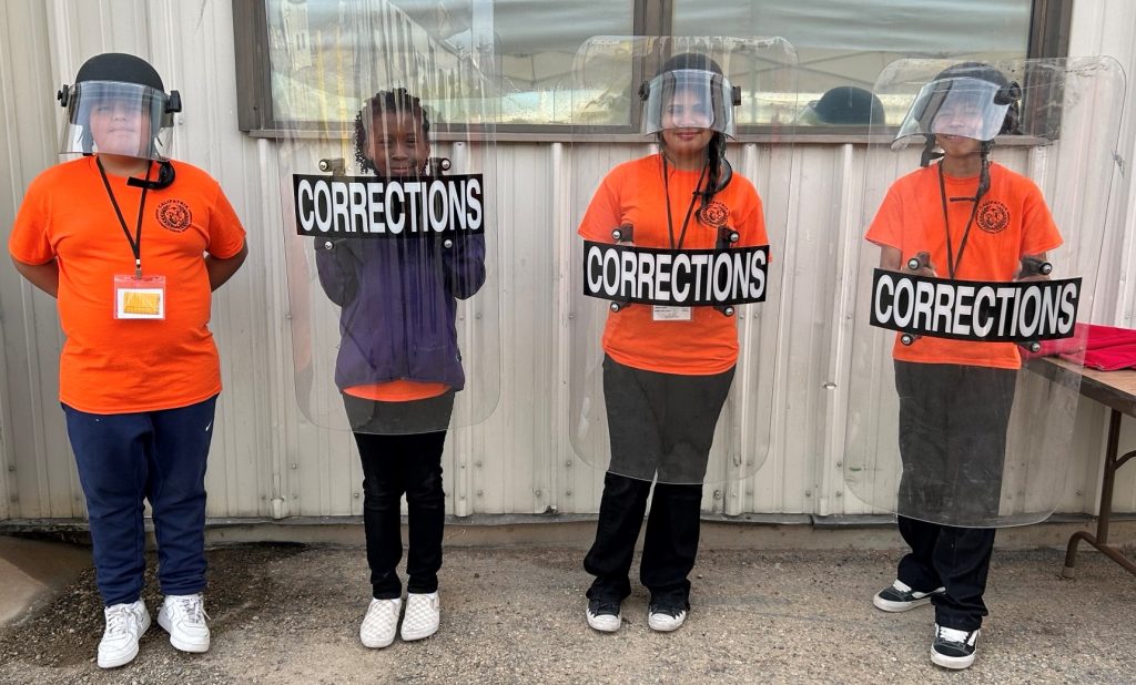 Kids try on gear during the Junior Correctional Officer Academy at Calipatria State Prison.
