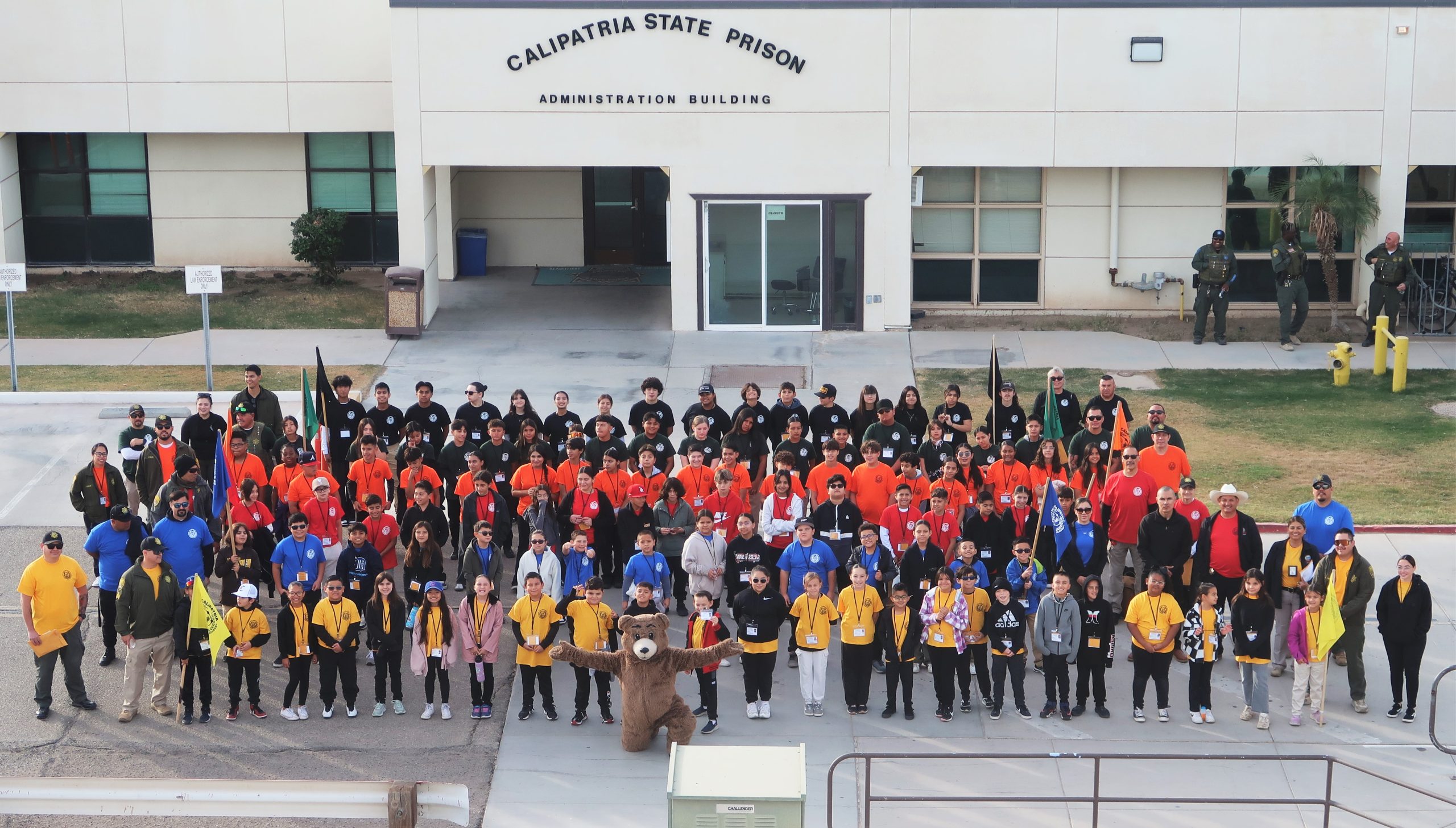 Calipatria State Prison's annual Junior Correctional Officer Academy group photo with a bear mascot.