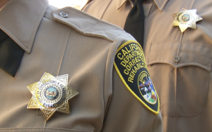 CDCR badge, uniform, and shoulder patch for correctional officers.