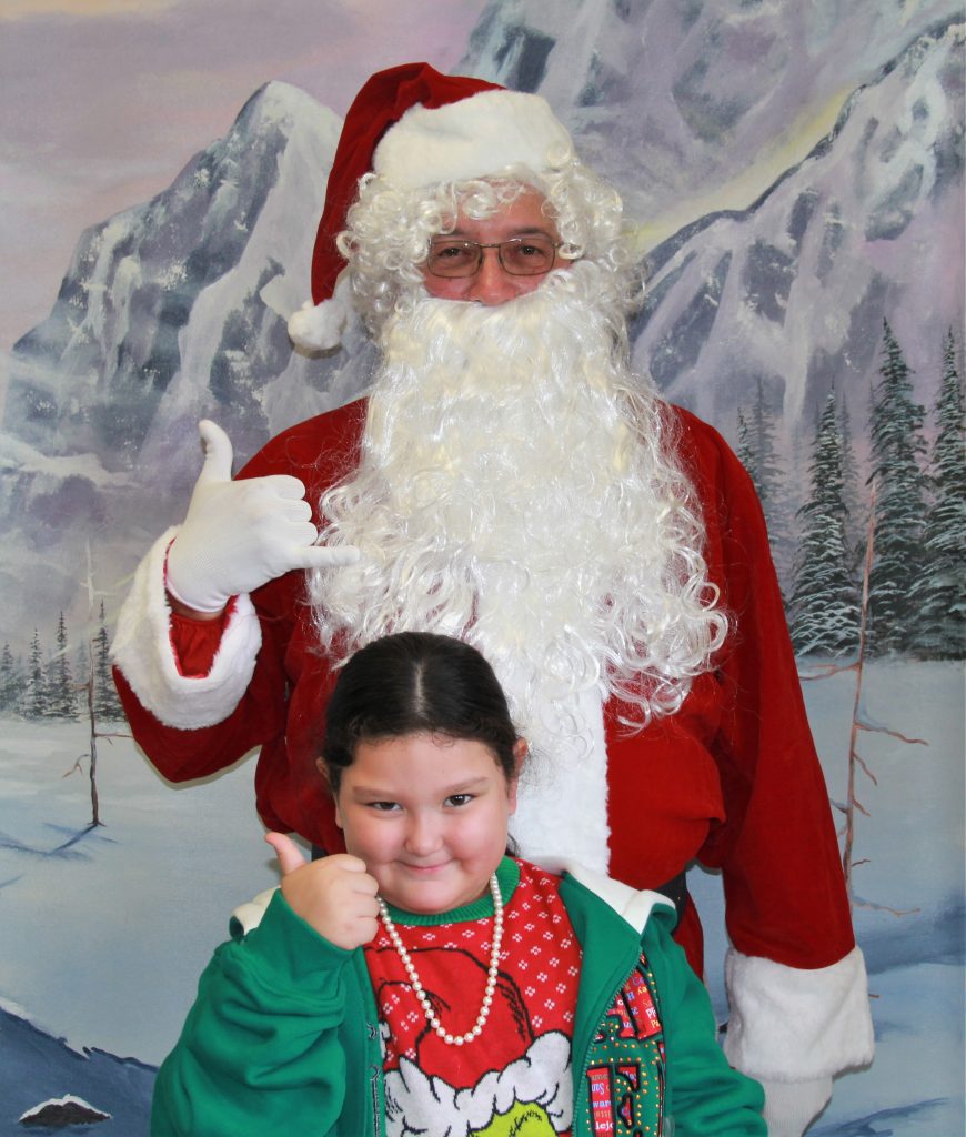 Santa with a child at CHCF in Stockton.