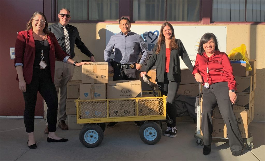 CIM leaders standing with boxes of supplies