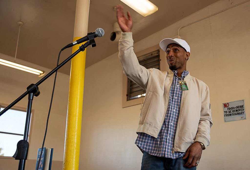 A young man, Joseph Herd, speaks at California Institution for Men with Glassman.